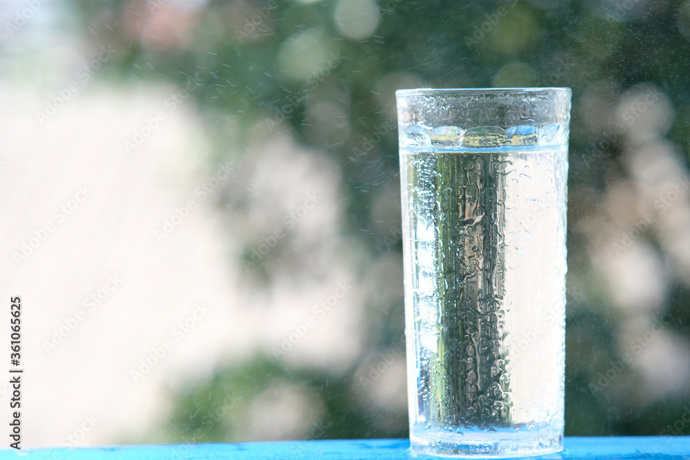 Sticker glass of water on wood table background and pouring drinking water