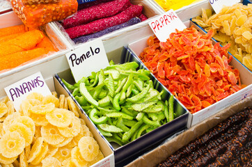 Colored sweet slices of candied fruit. Various dried fruits and eastern sweets on market.