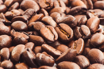 Roasted coffee beans background, close up