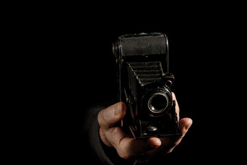 Vintage bellows camera in the hand of the photographer
