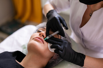 Skin care concept. A woman in a beauty salon during a facial skin care treatment