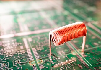 Copper wire stands on a green microcircuit