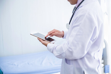 Doctor hold digital tablet touching on blank screen in hospital