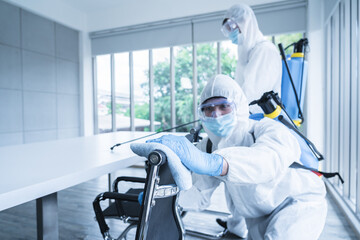 Specialist team in virus protective suite and mask spraying alcohol and cleaning covid19 infected area, Virus disinfection concept - obrazy, fototapety, plakaty