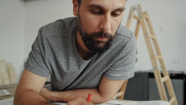 Close up video of carpenter calculating and saving the results. Shot with RED helium camera in 8K