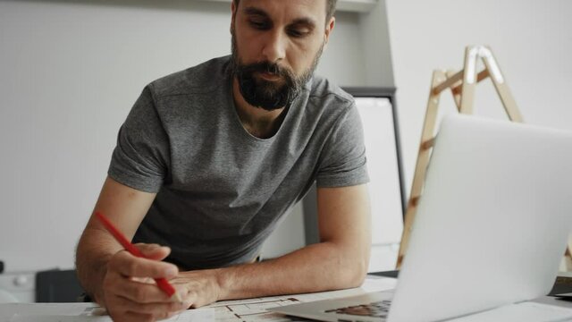 Handheld video of carpenter on a computer and saving results. Shot with RED helium camera in 8K