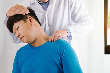 Doctor physiotherapist making neck massage to male patient in clinic or hospital