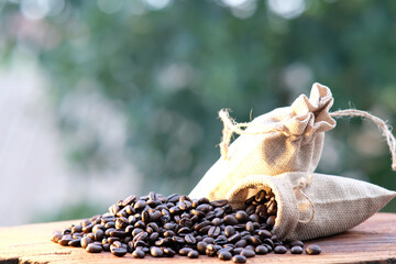 close up coffee beans and coffee cup on wood table background and space