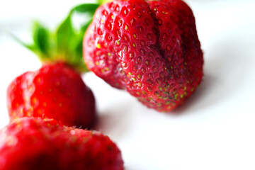Red juicy strawberries on a light table