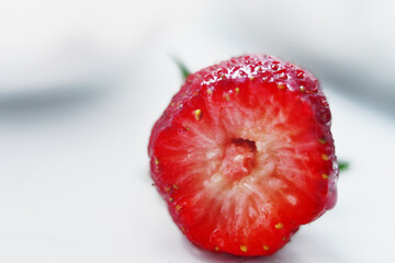 Red juicy strawberries on a light table