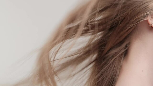 Closeup waving brunette hair in studio on a white background.