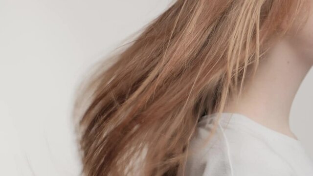 Closeup waving brunette hair in studio on a white background.