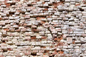 Old Brick wall surface close up. Bricks wall Texture. Loft interior and exterior design. Bricks in the wall. Brickwork close up view. Natural vintage stone walls pattern. Antique stonework Texture.