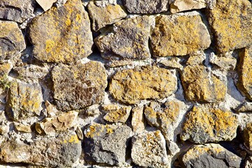 Ancient stone wall close up view. Old stonework Texture. Natural antique stone wall pattern. Construction industry raw materials. Natural Building materials. Vintage stone walls. Abstract backgrounds.