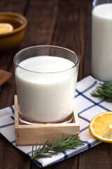 milk in glass on wood food background