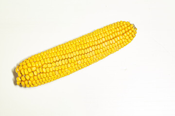 Yellow ear of corn on an isolated white background. Upraised phallic symbol. Use in topics on sexology, the problem of erectile dysfunction and gender relations