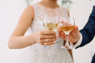 bride and groom holding champagne glasses
