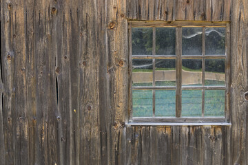 Vintage Window of old farm house barn. Wooden rustic background.