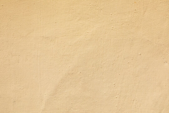 detail of ocre harmonic painted  plaster wall