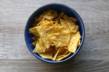 Bowl of tortilla chips on a table. Top view.