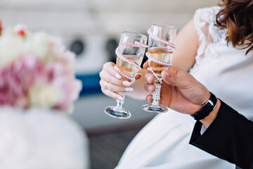 bride and groom holding champagne glasses