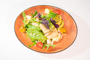 Tasty salad with grilled squid and avocado on a white background
