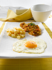 Huevos fritos con patatas y pisto. Fried eggs with potatoes and ratatouille.