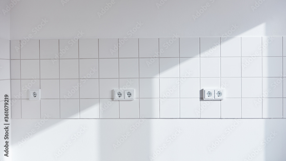 Canvas Prints white wall with tiles and outlet in empty kitchen