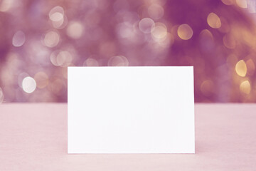 Empty paper greeting card, lights glittering bokeh. Celebrate, Christmas, New Year, holiday party background.