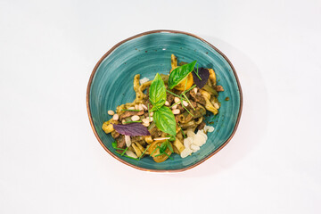 Delicious tagliatelle pasta and pesto on a white plate