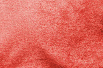 Red velvet background or velour flannel texture made of cotton or wool with soft fluffy velvety satin fabric cloth rose gold metallic color material