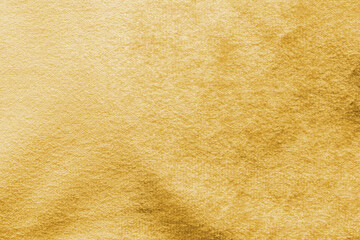Gold velvet background or golden yellow velour flannel texture made of cotton or wool with soft...
