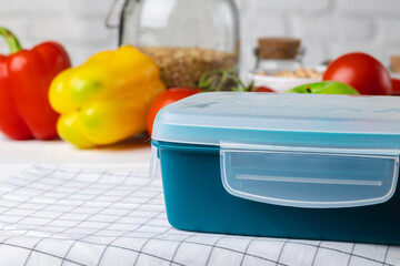 Closed plastic lunch box on kitchen table