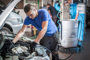 Car master mechanic working in auto vulcanizing and vehicle service workshop