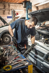 Car master mechanic working in auto vulcanizing and vehicle service workshop
