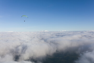 Paraglider above the clouds