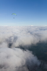 Paraglider above the clouds