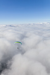 Paraglider above the clouds