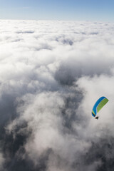Paraglider above the clouds
