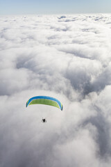 Paraglider above the clouds