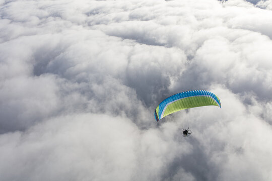 Paraglider above the clouds