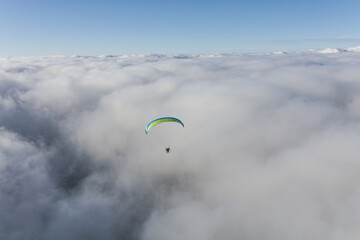 Paraglider above the clouds