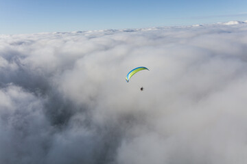 Paraglider above the clouds