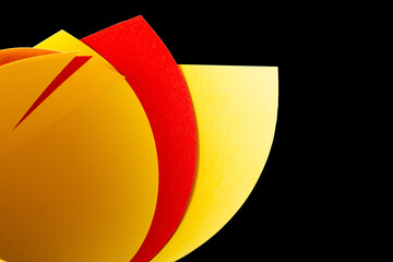 Yellow red paper on an isolated black background