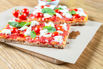 Pizza margarita with cherry tomato, basil and morzzarella cheese