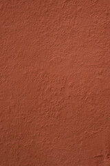 Texture of an uneven Terra cotta colored wall