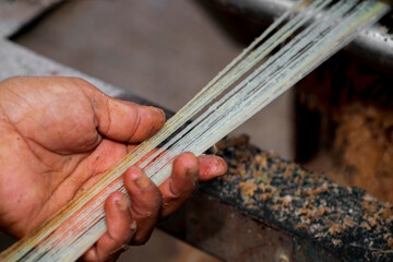 Fiber is being made from the banana tree. A Hand and Unwashed Banana tree fiber. Rubber fiber of banana tree. Agricultural waste product.