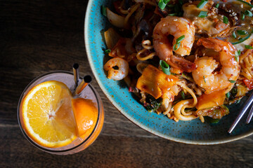 Asian wok with sea food and lemonade