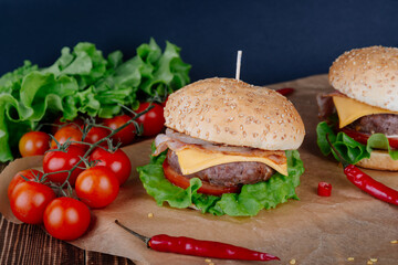 View of fresh tasty burger on wooden table. Food background.
