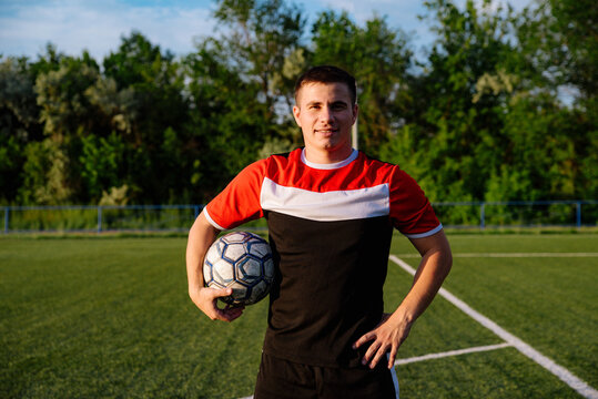 Soccer player with a ball in his hands - Powered by Adobe